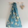 Blue tit on blossom laundry bag in blue